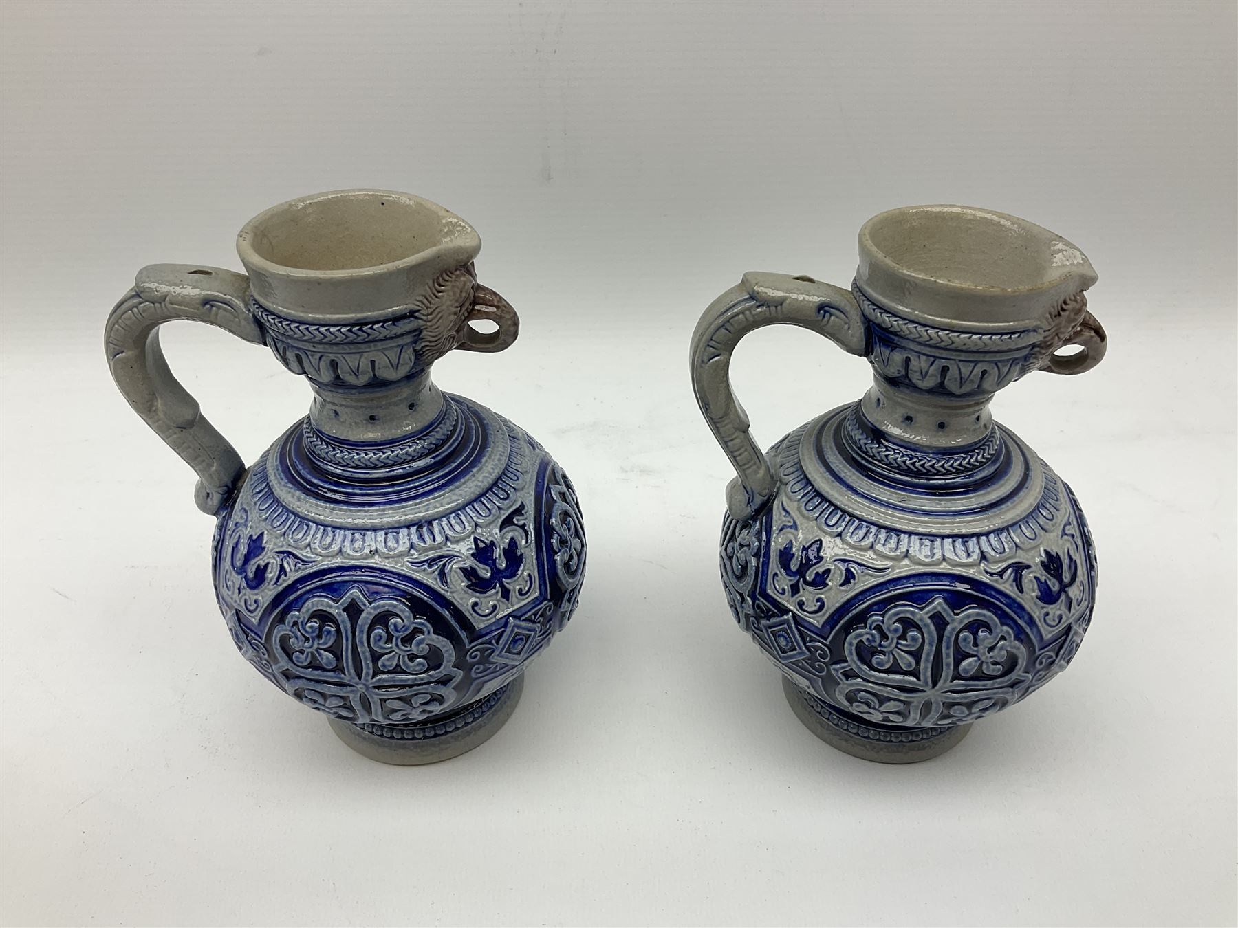 Pair of late 19th Century German Simon Peter Gerz salt glaze stone jugs, impressed mark to base, model number 550, H15cm