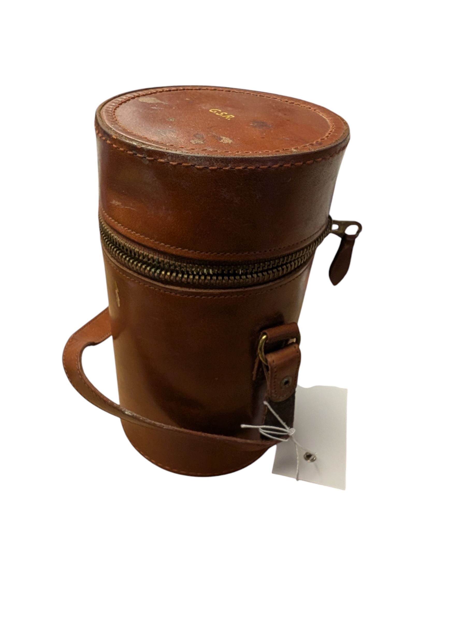 Set of three curved glass flasks with EPNS collars and lids, contained within a hide case with gilt initials