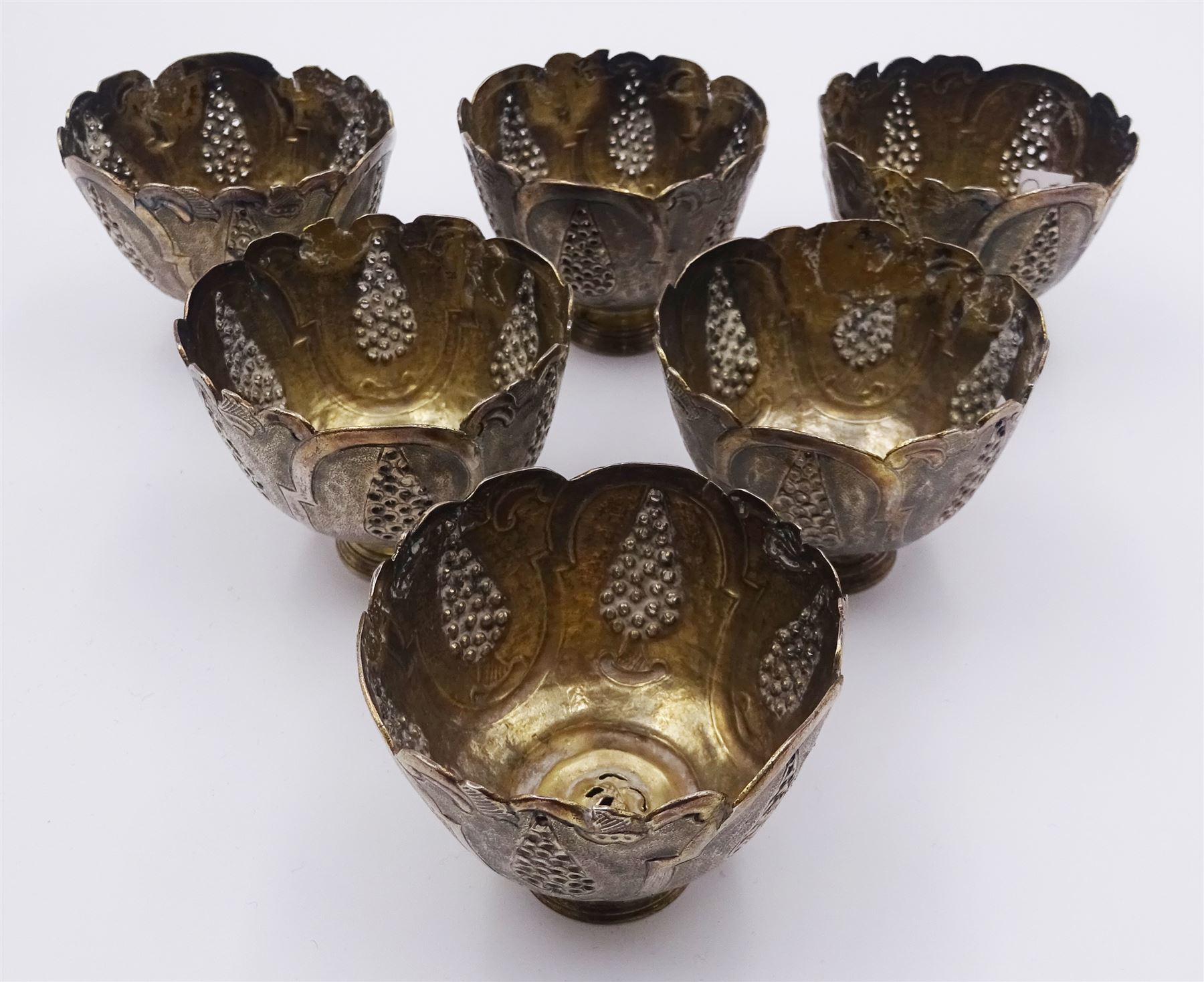 Set of six Ottoman Turkish silver zarfs or coffee cup holders, probably 19th century, the bowls with shaped rims and embossed and pierced decoration, upon stepped circular feet, D6cm H5cm
