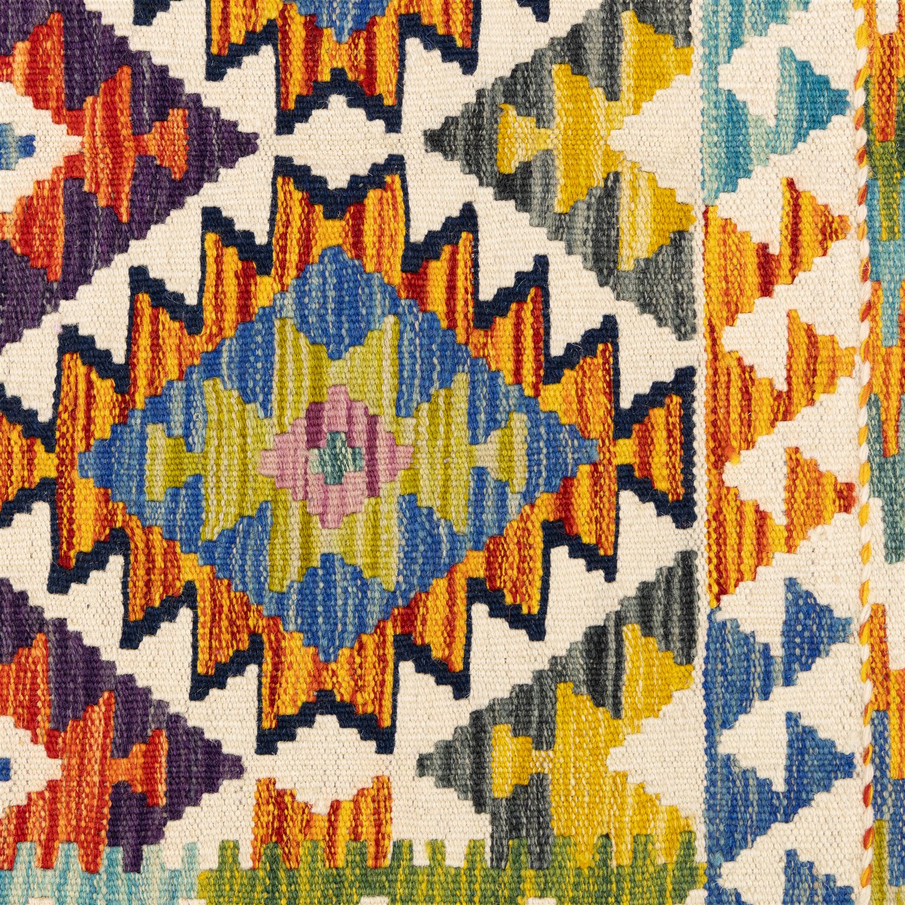 Two Chobi flatweave kilims with a repeating stepped diamond medallion design in live green, rust, teal, purple, and ivory, framed by chevron and geometric borders, 121x80cm & 87x60cm 