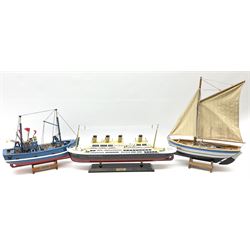 Wooden model of RMS Titanic, on a fixed black stand bearing plaque inscribed 'Titanic 1912', L54cm, H22cm, together with model of a sloop, gaff rigged on stand bearing plaque inscribed 'Sloop' L32cm, H42cm; and model of a fishing trawler on a stand bearing plaque inscribed 'Chalutier' L35cm, H28cm (3)