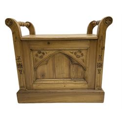 Gothic style pine stool with hinged box seat, decorated with flower head motifs, plinth base