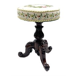 Victorian rosewood rise and fall piano stool, the floral needlework upholstered seat raised on floral and scroll carved tripod base