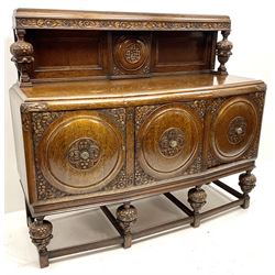 Mid 20th century carved oak West Riding sideboard, raised back, three shield panel doors on carved cup and cover supports joined by perimeter stretcher