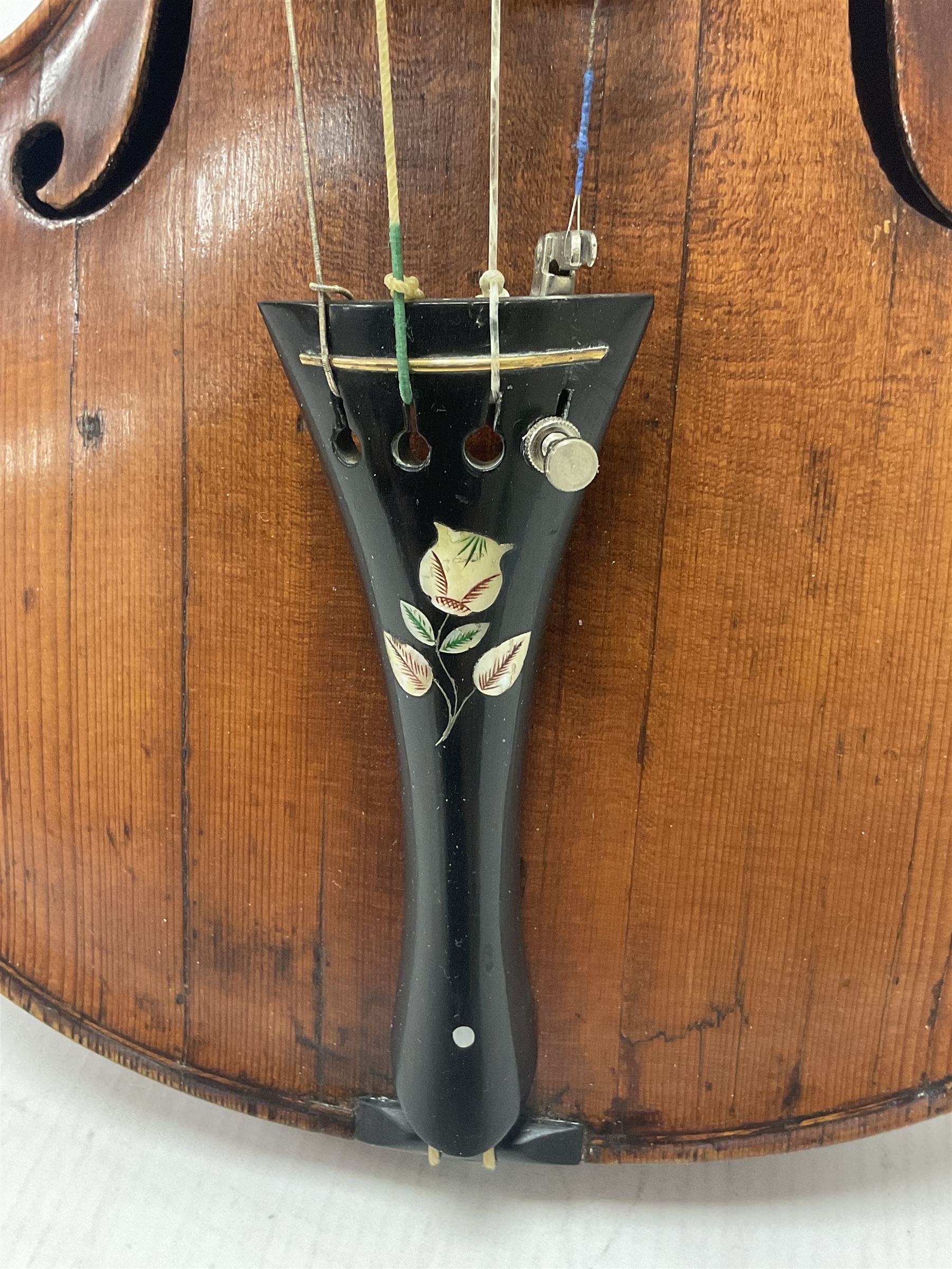 19th century full sized violin in a later hard case, decorative mother of pearl inlay to the tail piece Overall length 60cm No bow