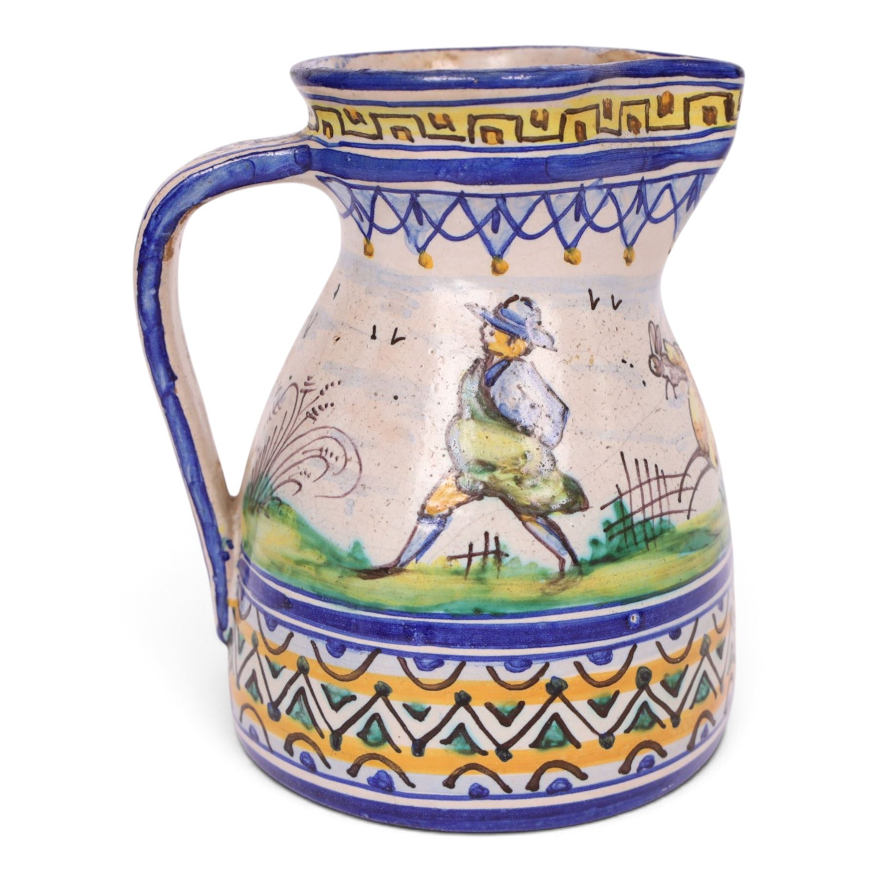 19th century Spanish faience jug with polychrome tin glaze decorated depicting a hunter and dog in a country scene within a geometric boarder, H18cm