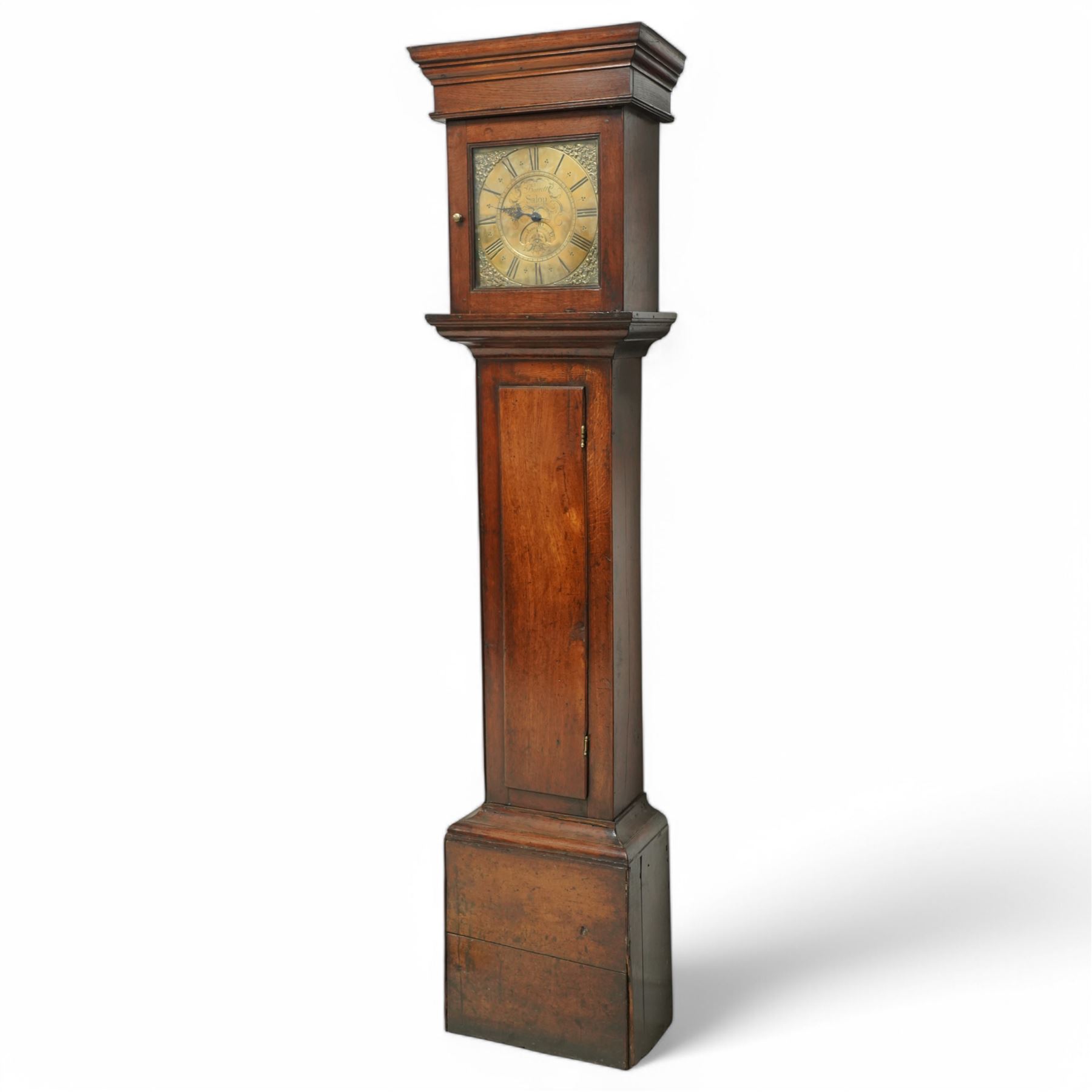 Barrett of Salop (Shrewsbury)-early 30hr provincial oak longcase clock c1730, with a flat topped hood and glazed square hood door beneath, long trunk door and a square plinth, brass dial with an engraved centre, makers name and date aperture, matching cast brass spandrels, single steel hand and engraved chapter with Roman numerals, half-hour markers and quarter-hour track, dial pinned directly to a chain driven count wheel striking movement, striking the hours on a bell. With weight and pendulum.  
