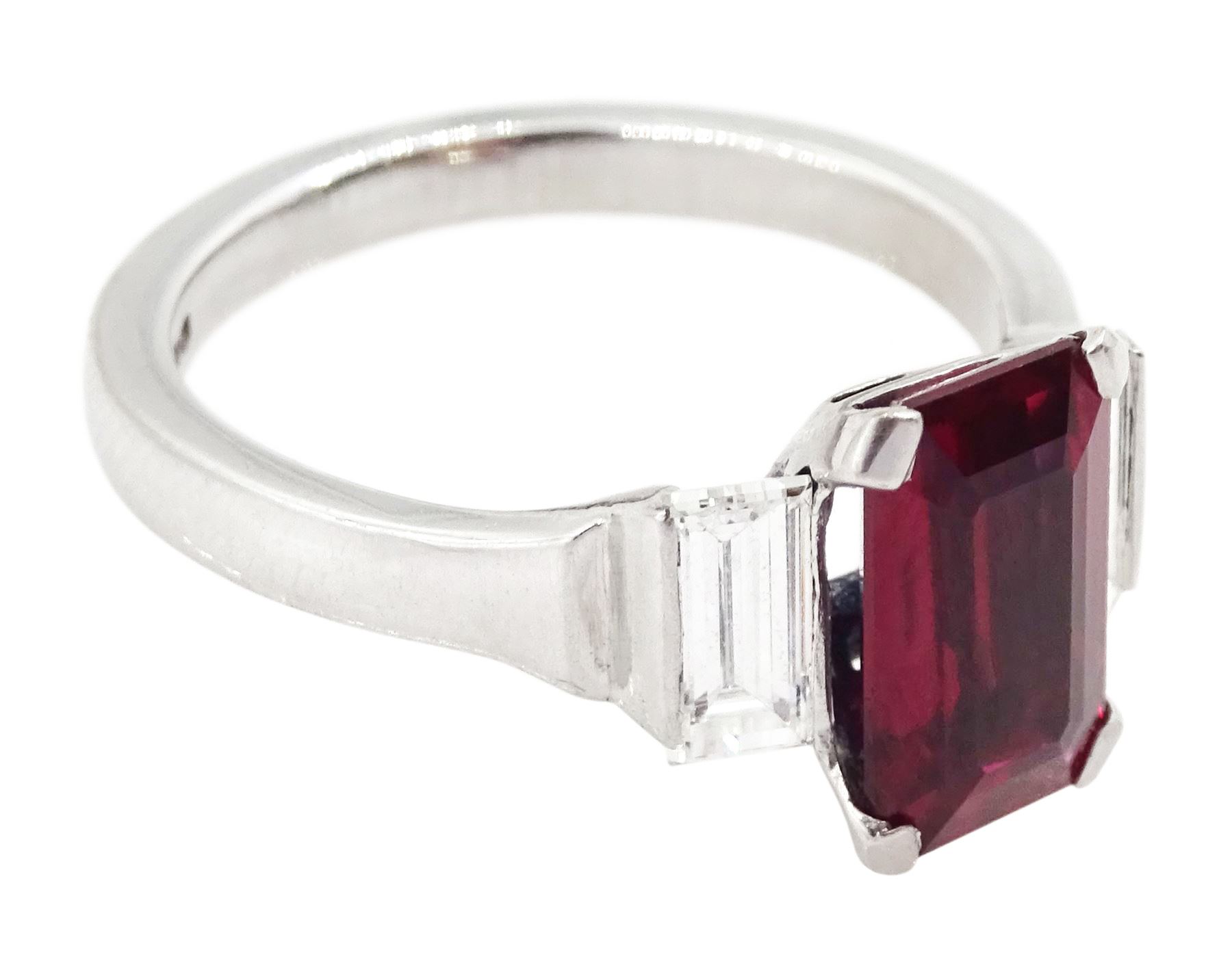 18ct white gold ruby and diamond three stone ring, single emerald cut Thai ruby of approx 2.00 carat, with a baguette cut diamond set either side, hallmarked, total diamond weight approx 0.60 carat