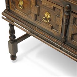 19th century Jacobean Revival oak dresser and rack, the upper section with open shelves and central cupboard, flanked by bobbin moulded uprights, the base fitted with three carved drawers with brass ring handles, raised on turned supports united by stretchers