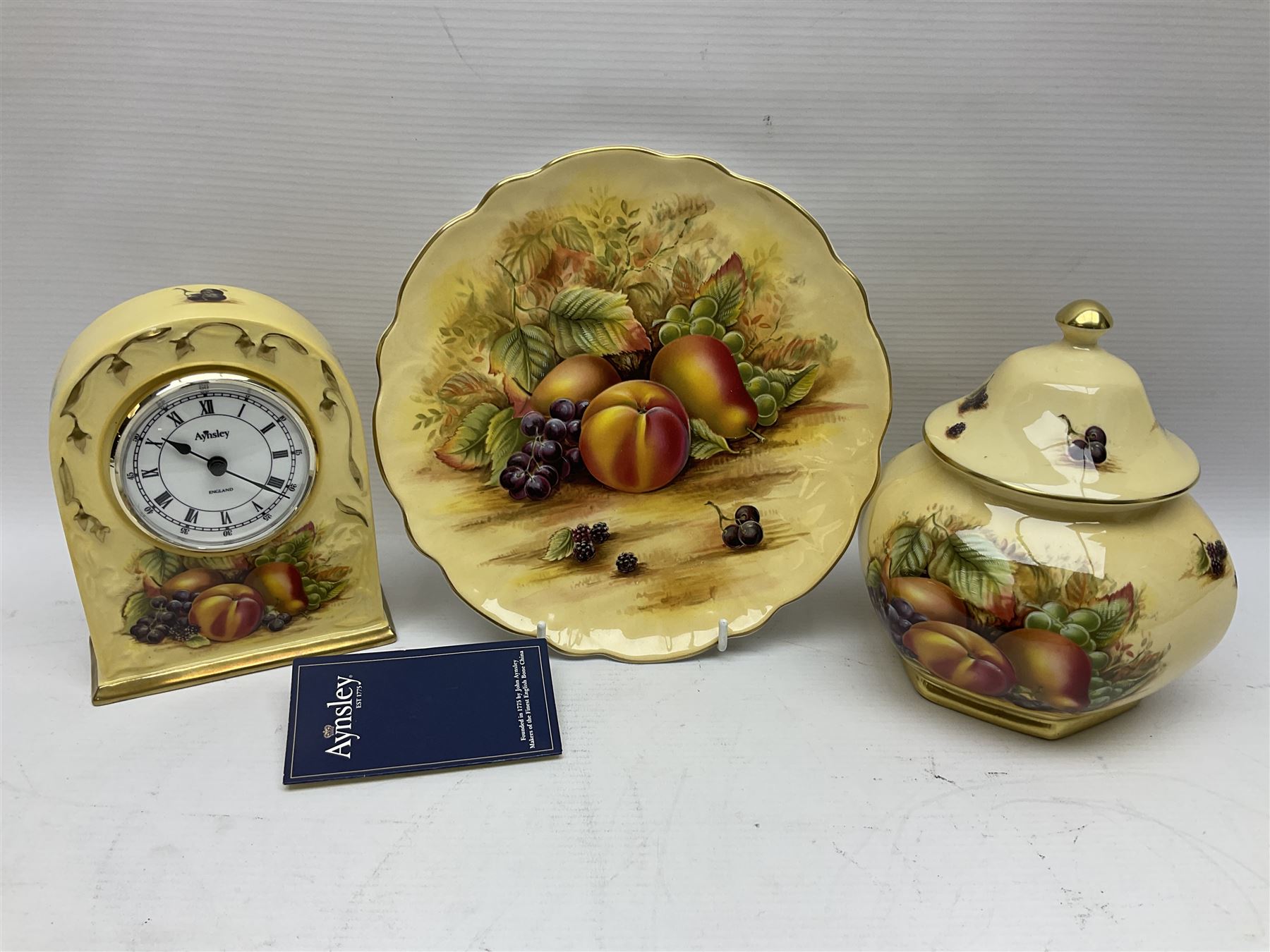 Aynsley Orchard Gold five coffee cans and saucers, mantel clock, plate etc 