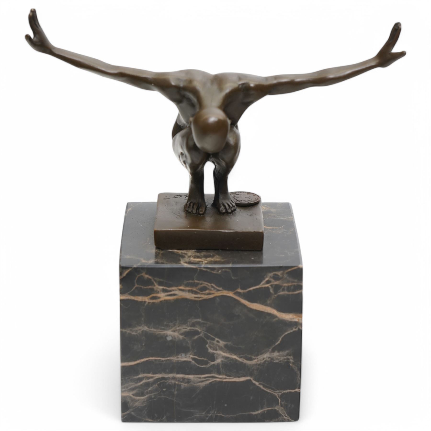 Bronze figure after Milo, a 'Power Of Silence', modelled as a male athlete crouched with arms outstretched upon a marble plinth, signed Milo, H15cm