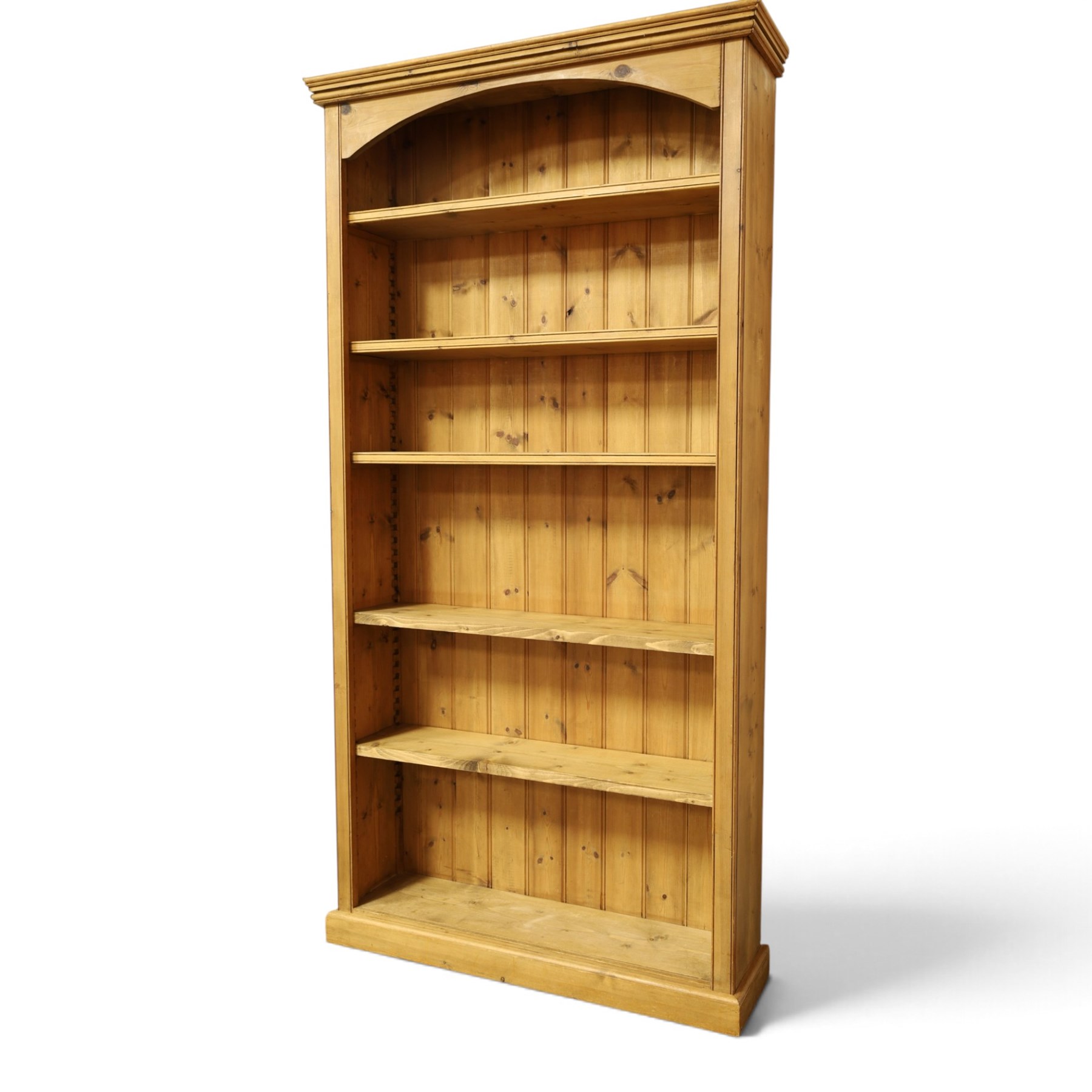Traditional large pine bookcase, moulded cornice above five adjustable shelves