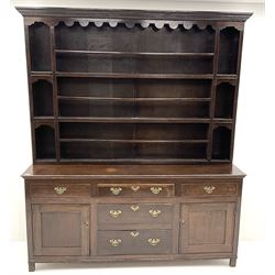 George III oak dresser raised three tier plate rack, projecting cornice, dentil frieze, five drawers and two cupboards, stile supports 
