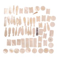 Collection of approximately sixty mother-of-pearl gaming tokens, including fish-shaped, re...