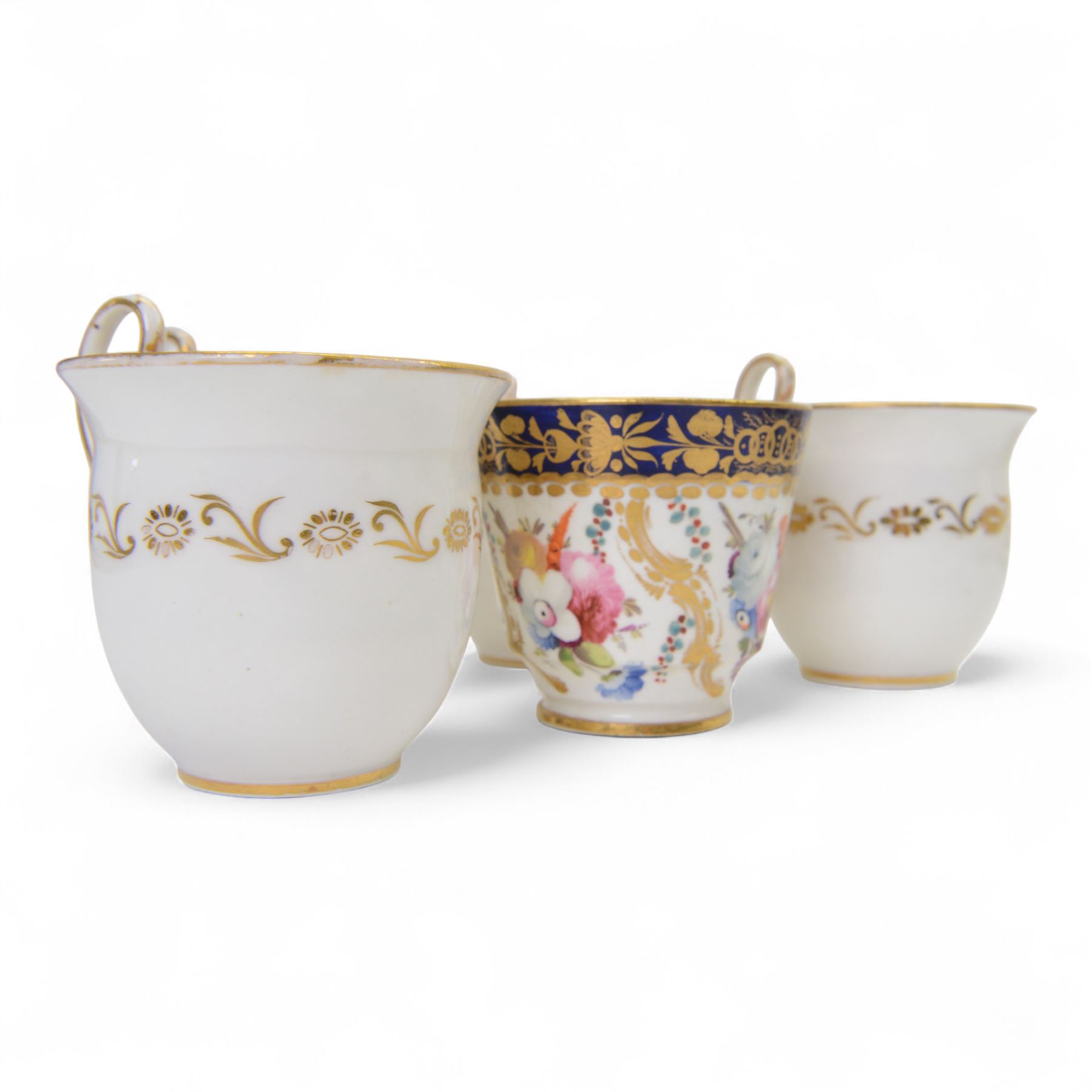 Coalport teawares, circa 1820-1840, comprising set of four trios, coffee cups, teacups and saucers, and slop bowl, decorated in the 830 pattern, with floral sprays and gilt shaped reserves, two further coffee cups and saucers, decorated with floral sprays upon blue grounds/with blue borders, and a similar coffee cup