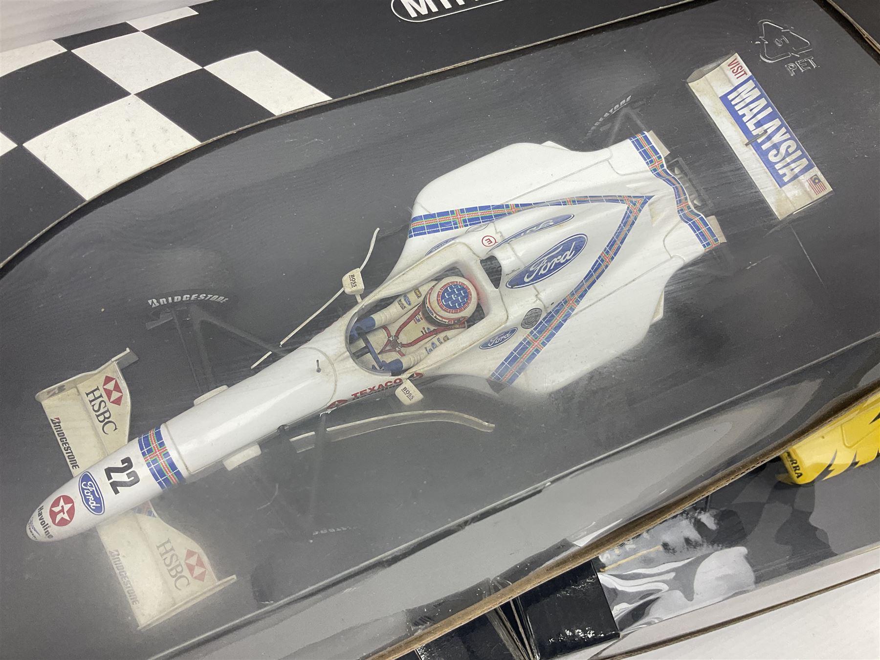 Three Minichamps 1:18 scale die-cast racing cars - Jordan Mugen Honda 198 D. Hill; Jordan Ford EJ13 G. Fisichella; and Stewart Ford SF 1 R. Barrichello; all boxed (3)