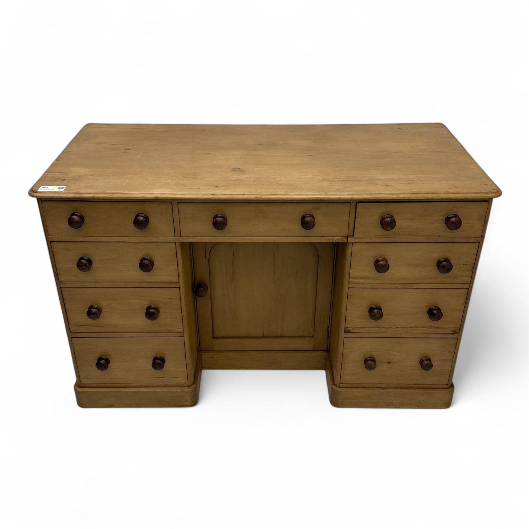 Late 19th-century Victorian stripped pine twin pedestal kneehole dressing table, the rectangular top above three short and three graduated drawers on each pedestal and a central cupboard, on a moulded plinth base 