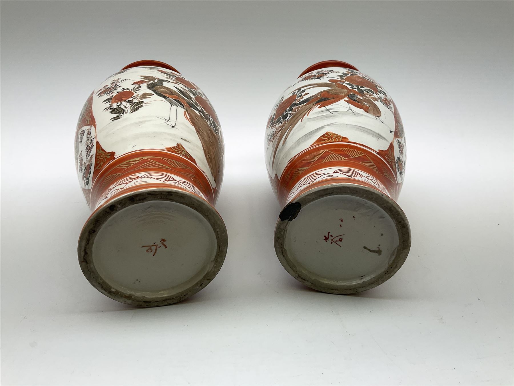 A pair of Japanese Kutani vases, of baluster form decorated with panels of birds and flowers, each with marks beneath, H30cm. 