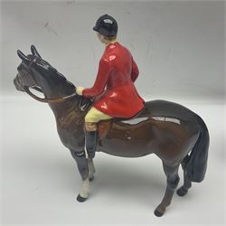 Beswick hunting group, comprising huntswoman on grey horse no 1730, huntsman on brown horse no 1501, fox figure no 1440 and eight fox hounds, all with printed marks beneath (11)
