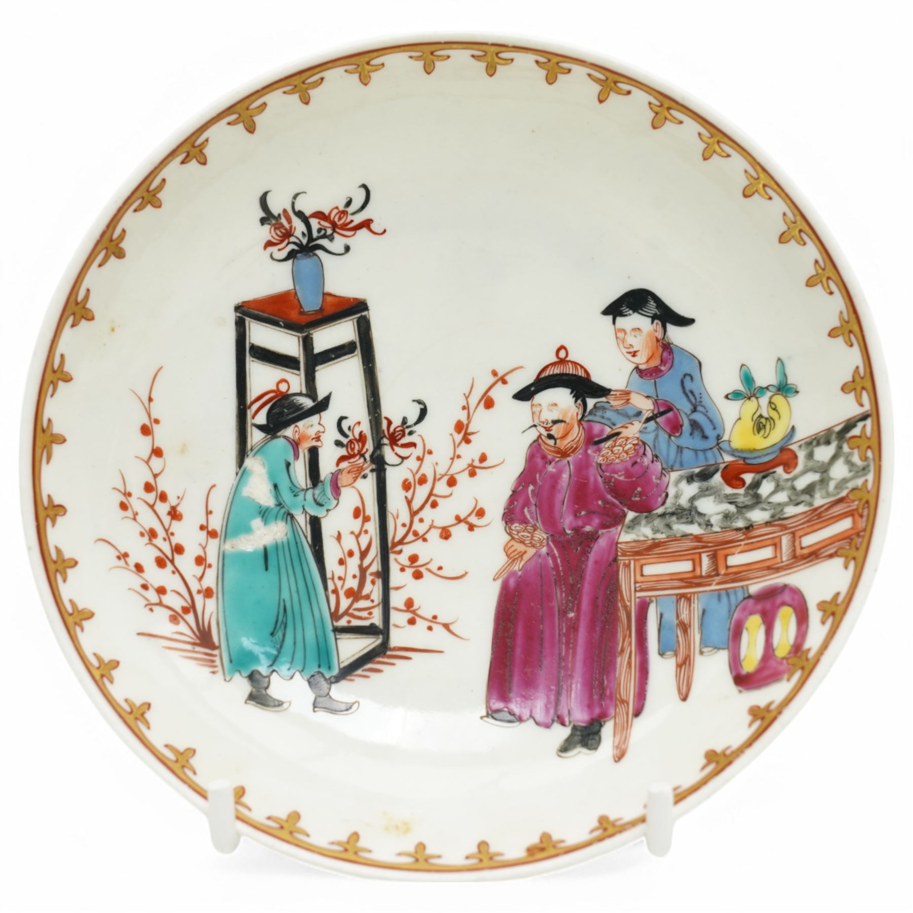 18th century Worcester trio, comprising coffee cup, small bowl and saucer, decorated with a Chinese scene of a flower seller in polychrome enamels, within gilt spearhead borders, saucer D12cm (3)