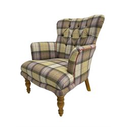 Traditional shaped armchair, upholstered in deep buttoned purple tartan fabric with red piping, raised on turned and tapering stained beech supports