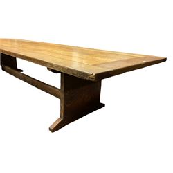 Large early 20th century ecclesiastical oak refectory dining table, rectangular top over end supports with sledge feet, united by single stretcher