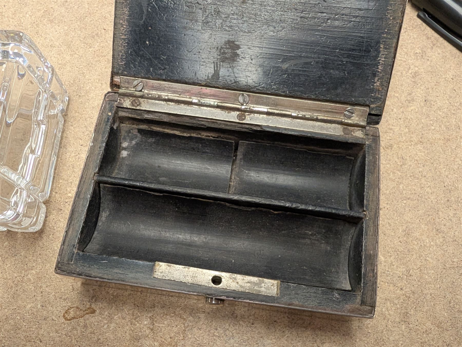 Two silver mounted boxes, including embossed example, decorated with cherubs, birds and scrolls, and a square glass example engraved with initials, both hallmarked 