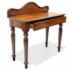 Victorian mahogany side table, raised back with scroll-moulded edge over a rectangular top, raised on turned octagonal supports