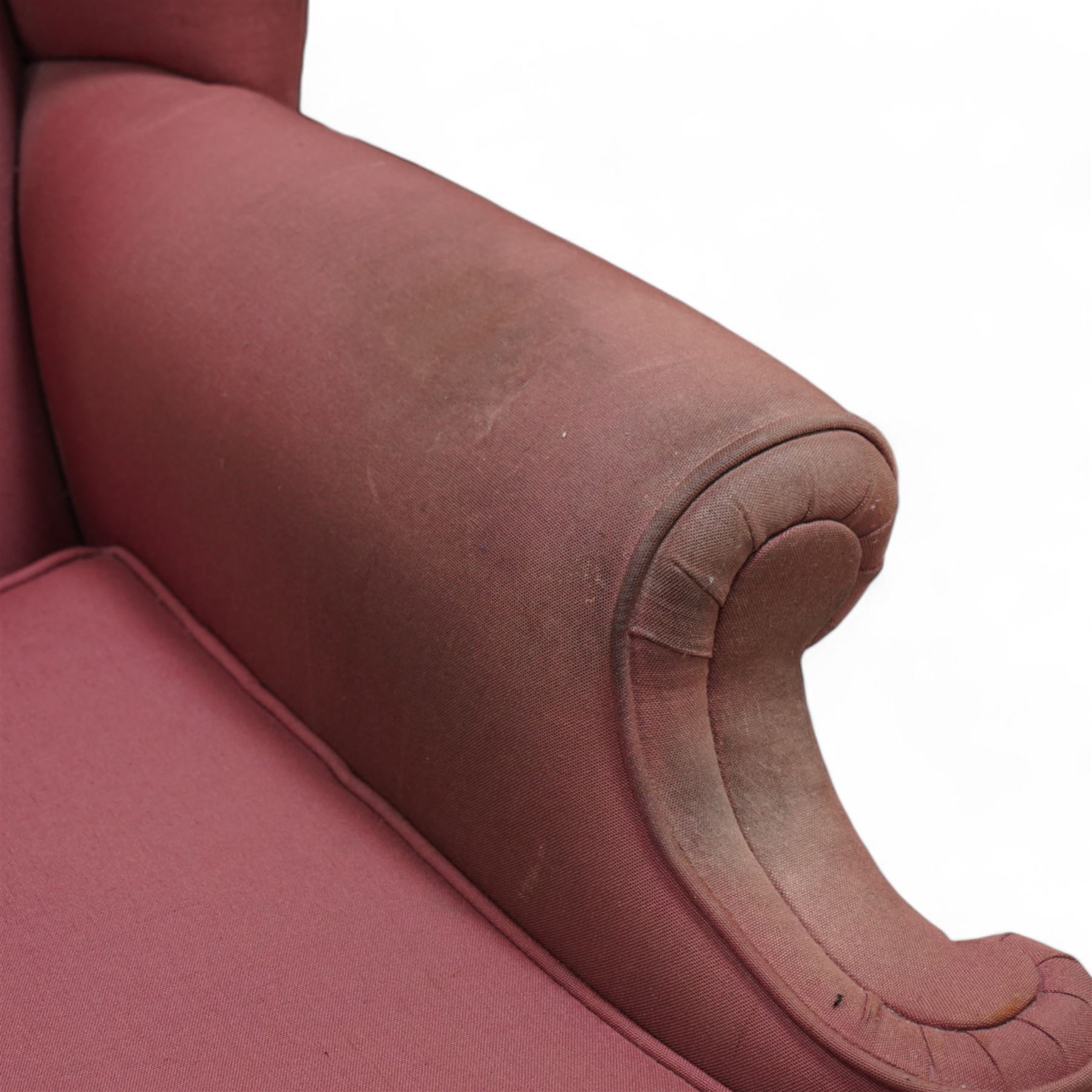Georgian design mahogany framed wingback armchair, upholstered in rouge fabric, on ball and claw feet with foliate cartouche decoration 