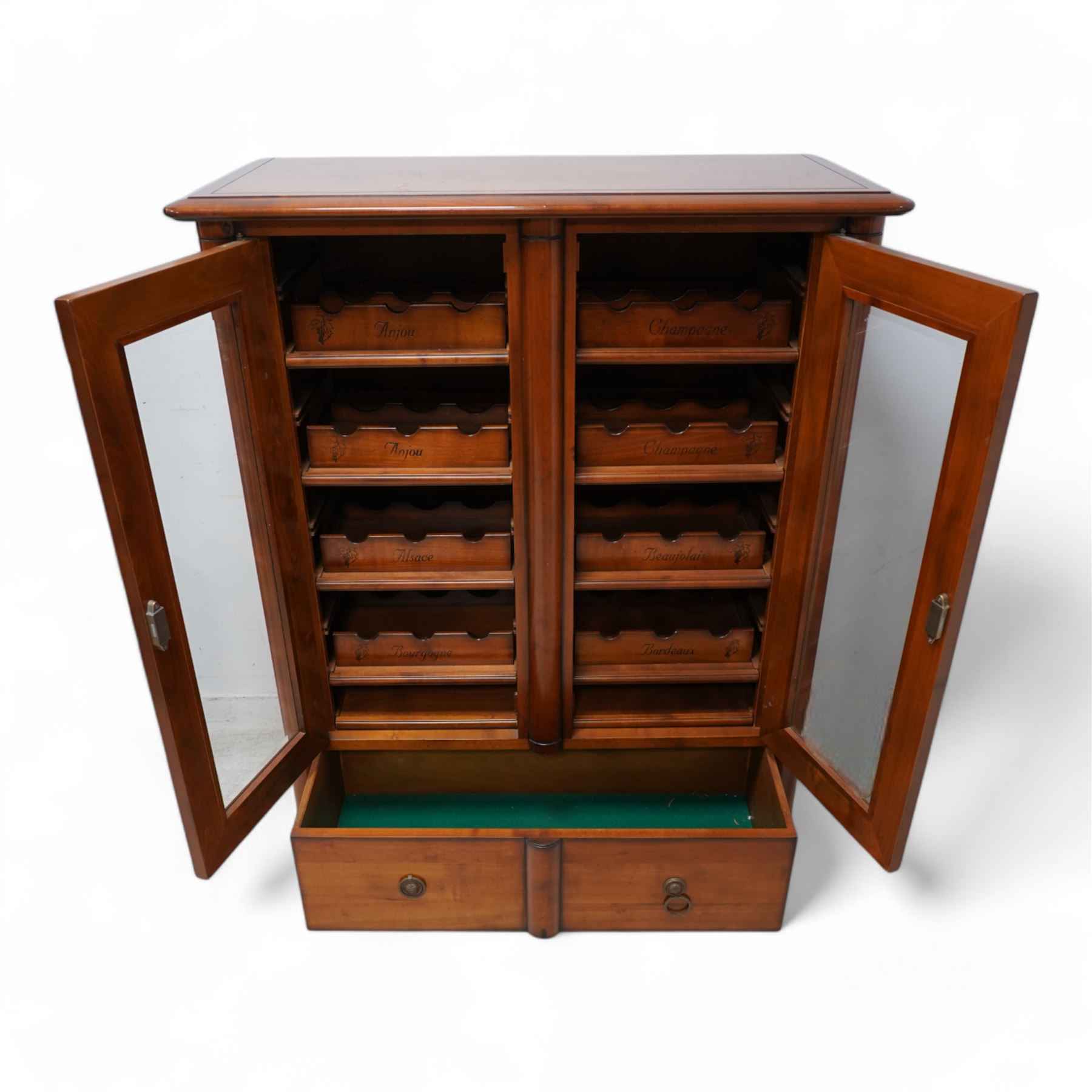 Cherrywood wine rack cabinet, moulded rectangular top over two glazed doors, fitted with eight slides each with three bottle holders inscribed with various wine types, single long drawer to the base 