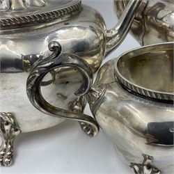 Five piece Edwardian silver tea service, comprising teapot and coffee pot, each with ebonised scroll handle, tea caddy with hinged cover, twin handled open sucrier, and milk jug, each of rounded bombe form, upon four paw feet, hallmarked William Adams Ltd, Birmingham 1904 and 1905, coffee pot H26cm
