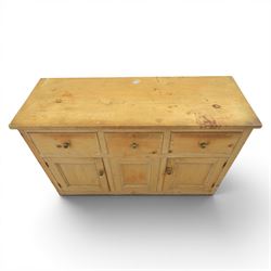 Victorian pine dresser base, with rectangular plank top, above three short drawers over two cupboard doors