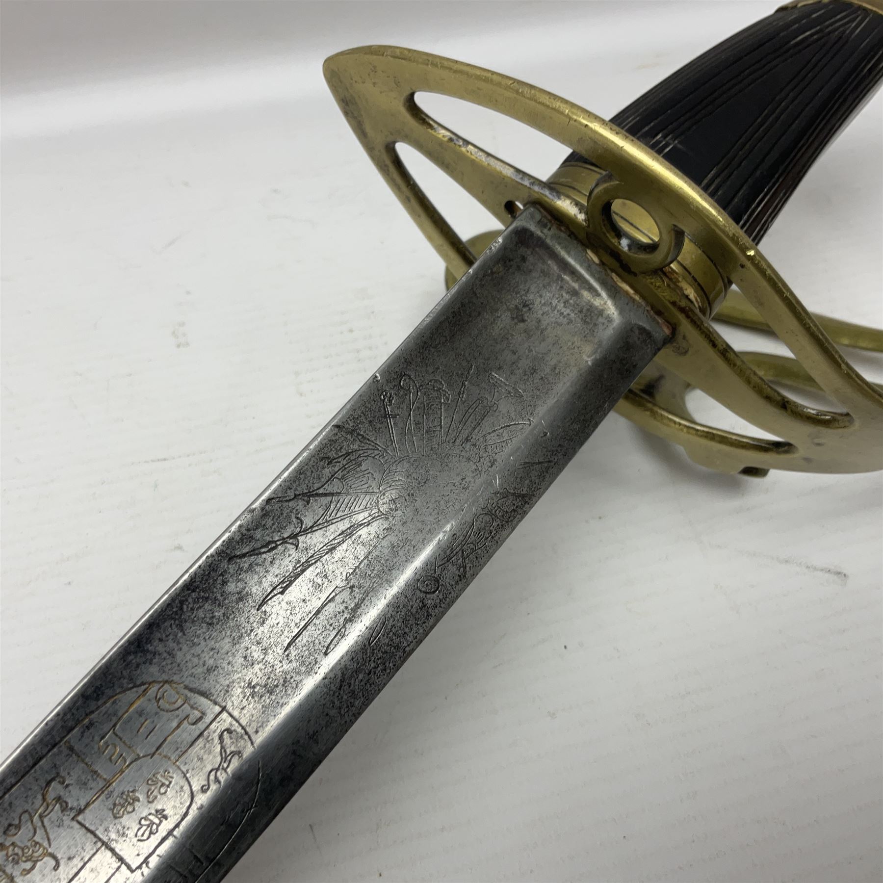 Late 18th century sword, the Spanish 79.5cm curving fullered blade engraved with the Royal Cypher, battle trophies and 'Viva Espania' banner, French Sabre de Mineur brass three-bar hilt with ebonised reeded grip L93.5cm overall (no scabbard)