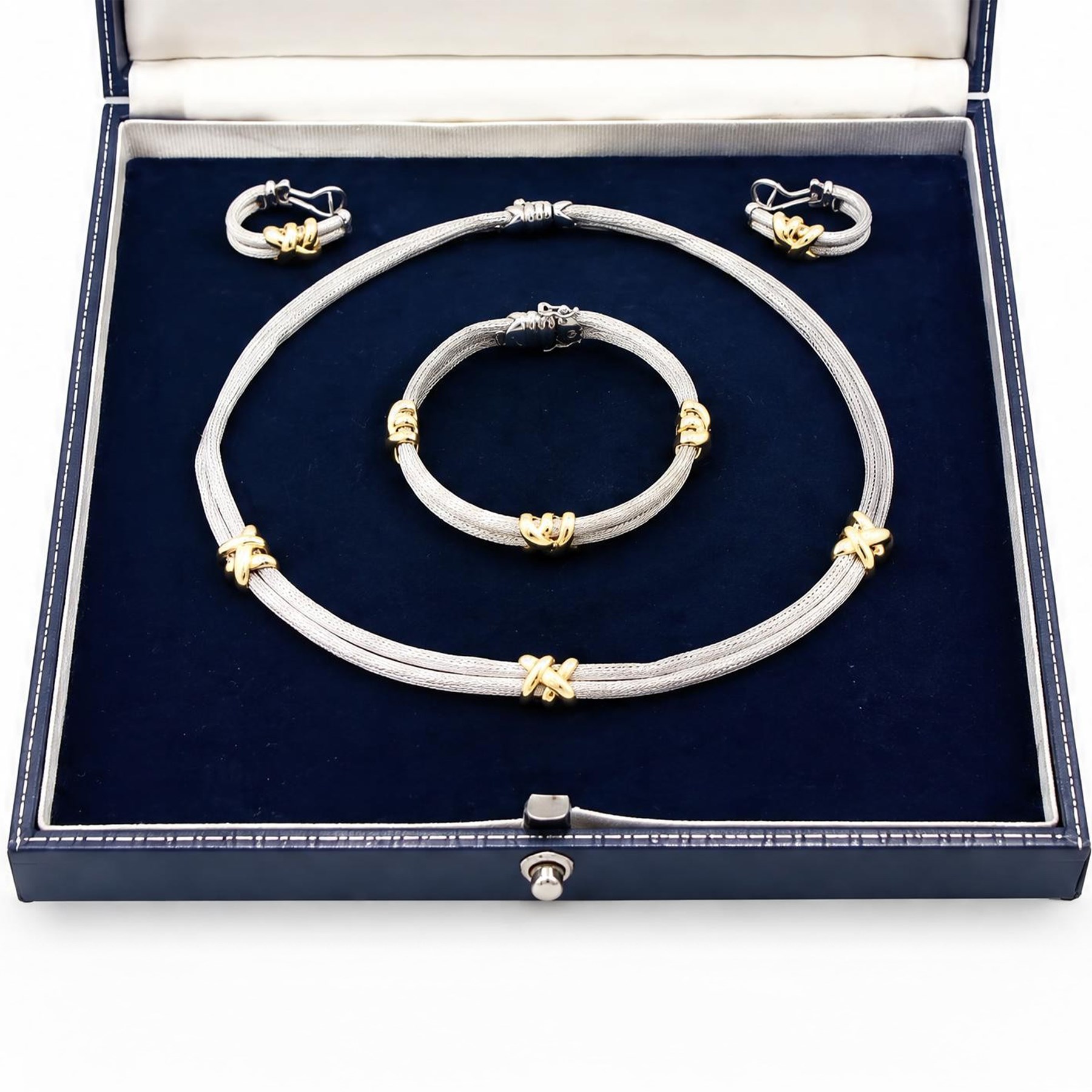 Silver and 18ct gold necklace, bracelet and earrings, two rows of silver mesh, spaced by gold cross motifs, retailed by Mappin & Webb, boxed
