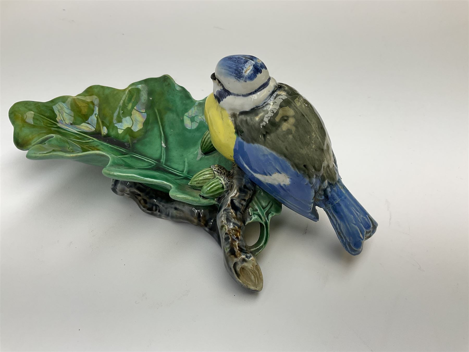 Minton majolica leaf dish, modelled as a Blue Tit perched on a branch with acorns and an oak leaf, date cypher for 1868, impressed marks beneath, L21cm. 