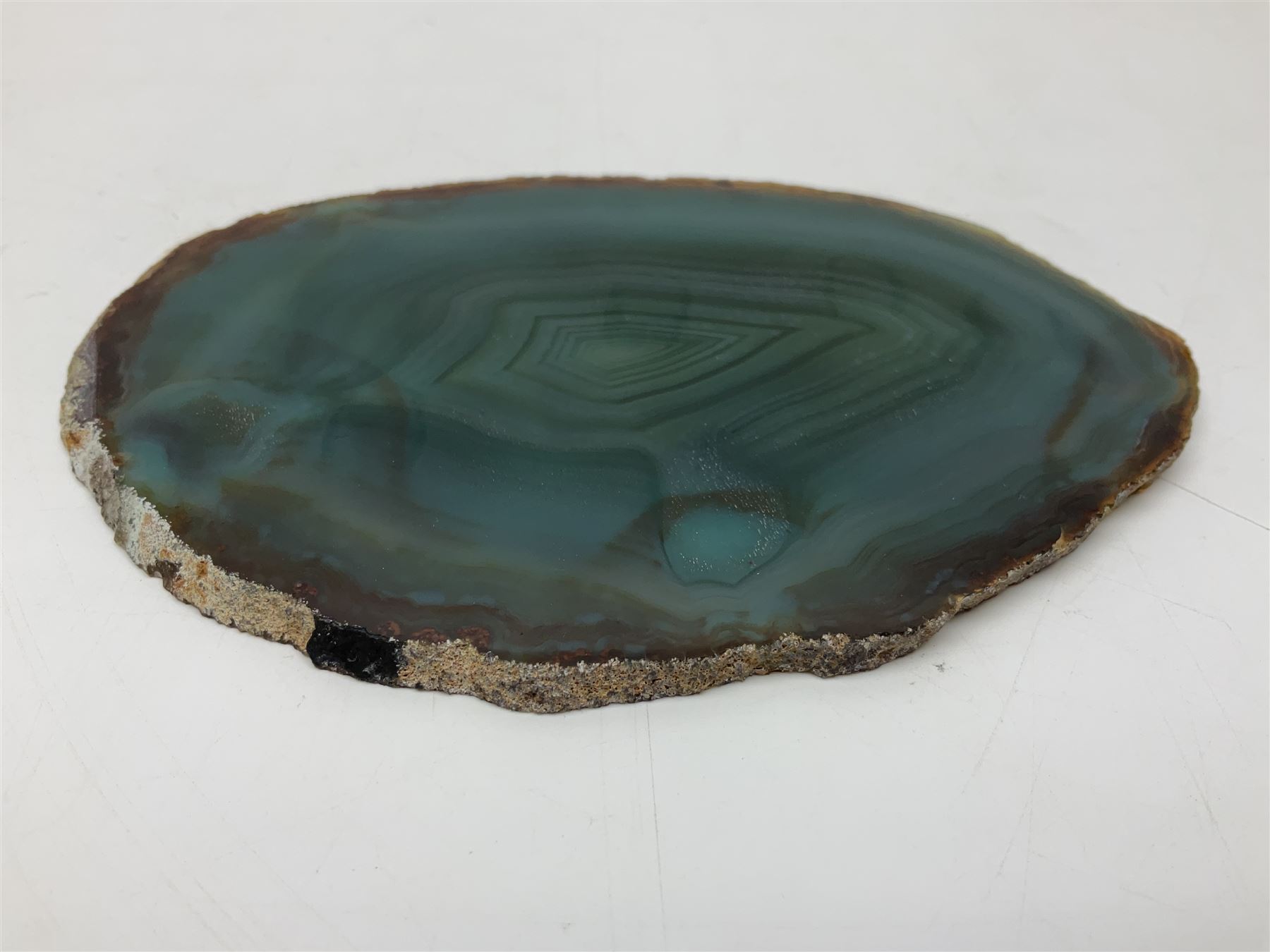 Pair of green agate slices, polished with rough edges raised upon silvered metal stands, H19cm