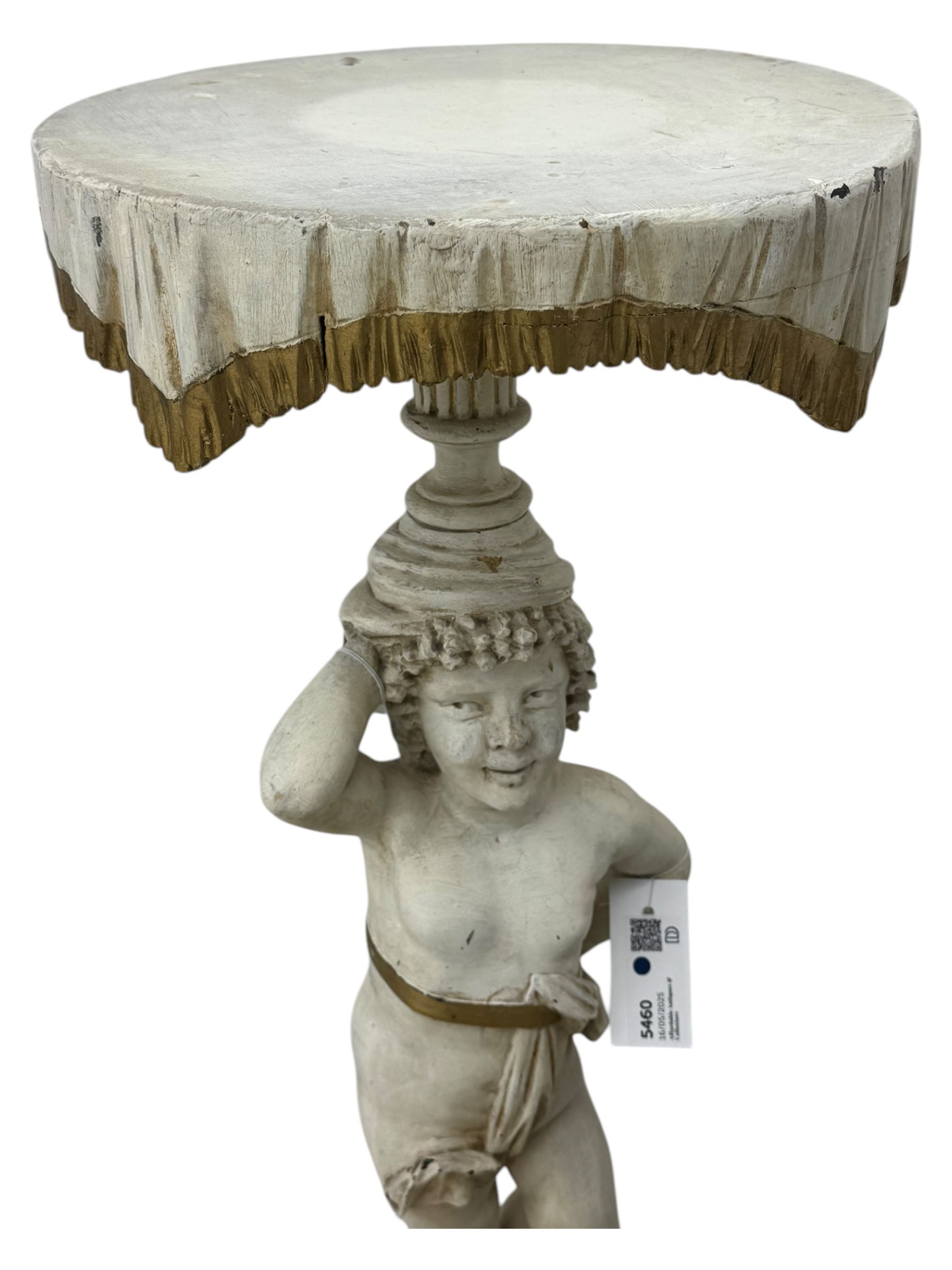 Early 20th century figural torchère, modelled as a standing putto supporting a circular top with tasselled drapery effect, raised on a circular base with foliate moulding; together with a 19th century large carved wood fragment, triangular form with high relief fruit, foliage and shell motif (H23cm, W129cm)