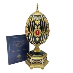 Franklin Mint House of Faberge; The Imperial Jeweled Egg Chess set, the egg opening to reveal a chess board, with a draw to the hexagonal base holding the miniature chess pieces, H23cm 