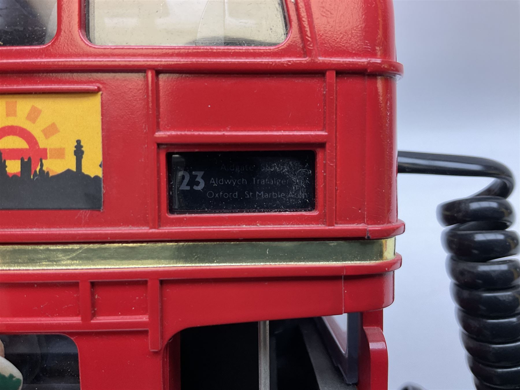 Novelty telephone in the form of a London Routemaster bus, c1997, fitted on wooden plinth with modern connection L25.5cm