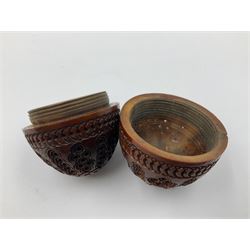 Three 19th century coquilla nut pomanders or flea catchers, two of egg shaped form and the third of barrel from with carved and pierced decoration and screw threaded join, largest H8cm