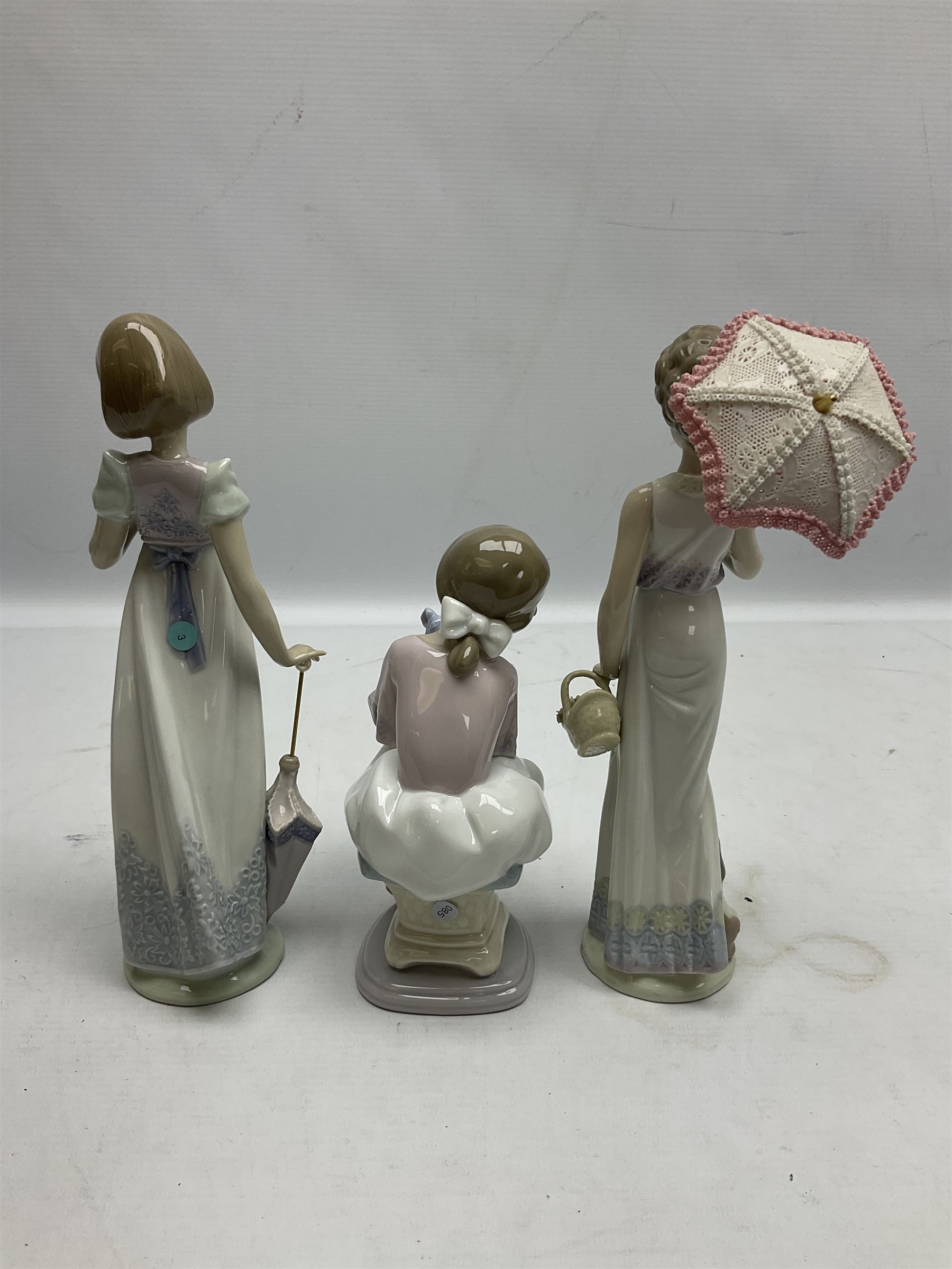 Three Lladro figures, comprising Garden Classic, signed no 7617, Summer Stroll no 7611 and Best Friend no 7620, all with original boxes, largest example H24cm 