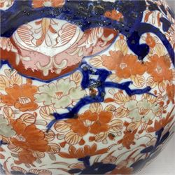 Pair of large 19th century Japanese Imari porcelain bottle vases, painted with shaped reserves of peonies, chrysanthemums and prunus blossom, each H46cm