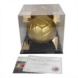 Limited edition football signed by Geoff Hurst to commemorate 50 years since England won the Football World Cup in 1966, a gold coloured football signed in black marker pen to one side, the ball stamped England 66W Celebrating 50 Years, contained within a Perspex display case, with certificate of authenticity from Northern Promotions