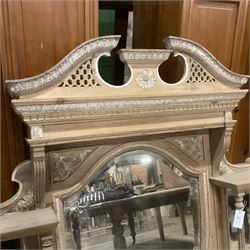 Late 19th century pine and gesso mirror back or wall mirror, pierced broken swan neck pediment decorated with foliate and central flower head motif, shield shaped bevelled mirror, the spandrels decorated with scrolled foliate decoration, two tier shelves on turned and fluted supports  - THIS LOT IS TO BE COLLECTED BY APPOINTMENT FROM THE OLD BUFFER DEPOT, MELBOURNE PLACE, SOWERBY, THIRSK, YO7 1QY
