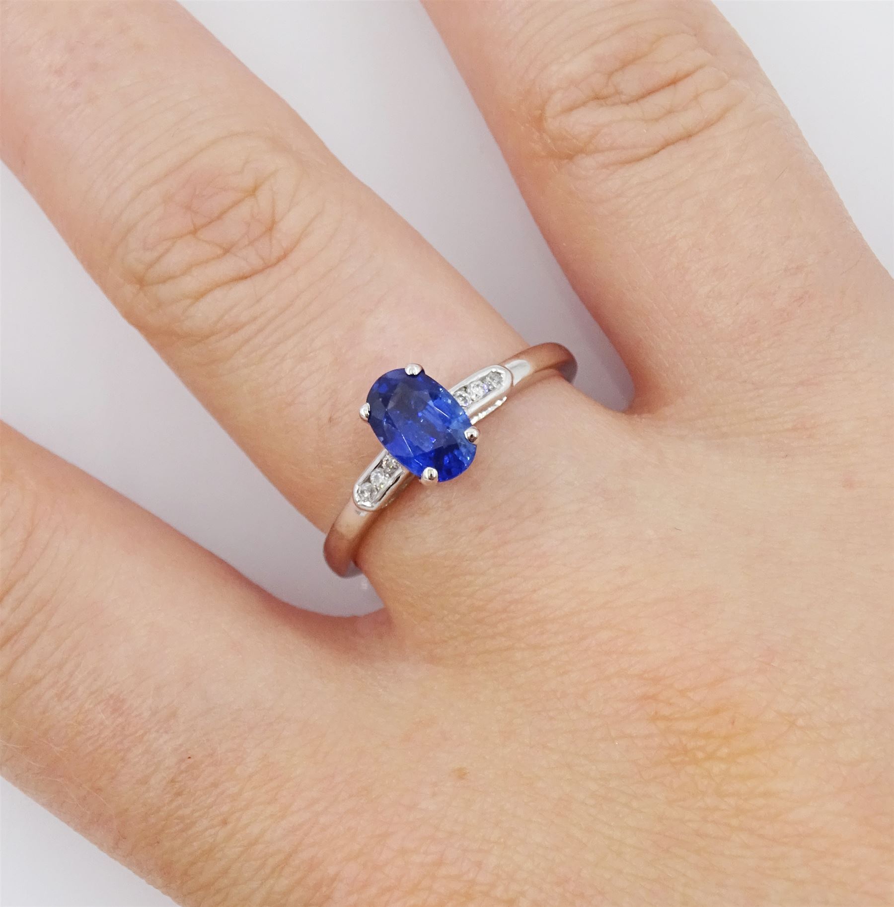 18ct white gold sapphire and diamond ring, single oval cut sapphire of approx 1.20 carat, with diamond set shoulders, hallmarked