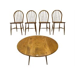 ercol elm and beech dining table, oval drop leaf top, and set four hoop and stick back dining chairs