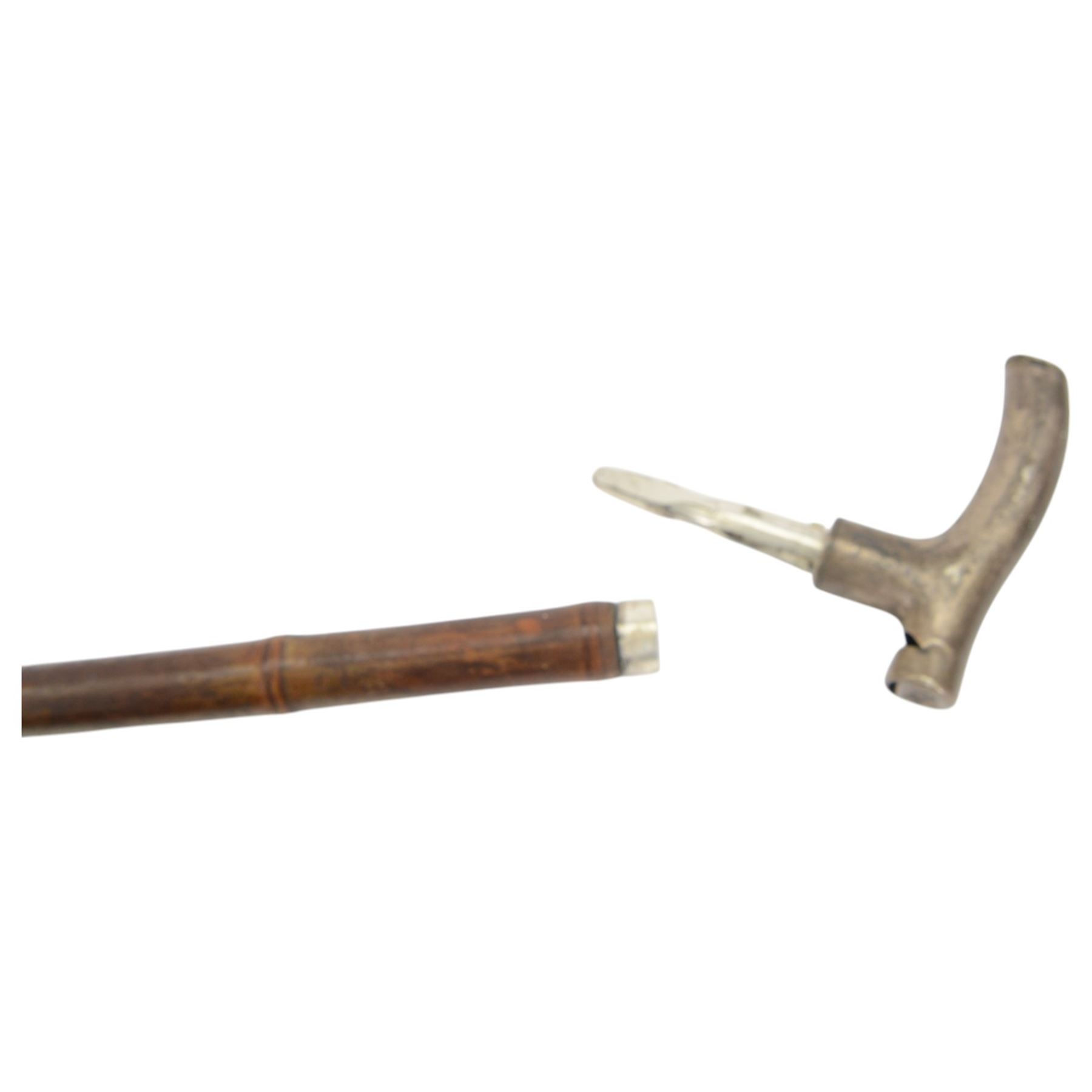 20th century novelty walking stick, the L-shaped metal handle as a whistle, bamboo cane, together with another novelty walking stick hardwood stick topped with a metal handle engraved A. Nutt, the top unscrewing to reveal an inner compartment containing a metal Irish flute, largest L96cm 