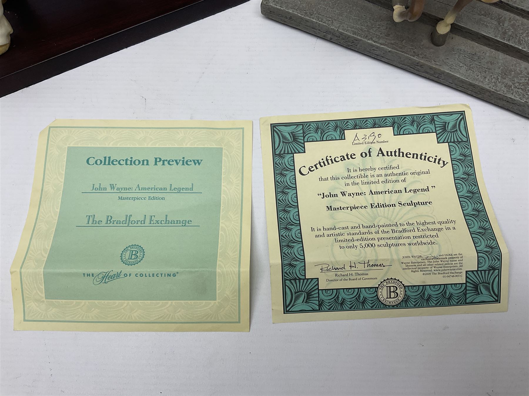 Beswick matte Hereford Bull, with stamped mark beneath, on wooden plinth, together with a limited edition Bradford Exchange John Wayne model, tallest H36cm