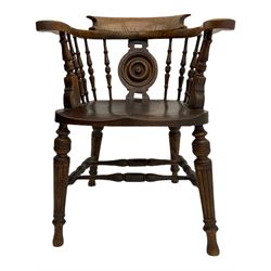 Late Victorian oak smokers bow armchair, with turned splat and spindle gallery over shaped seat, raised on turned supports united by double 'H' stretcher W61cm
