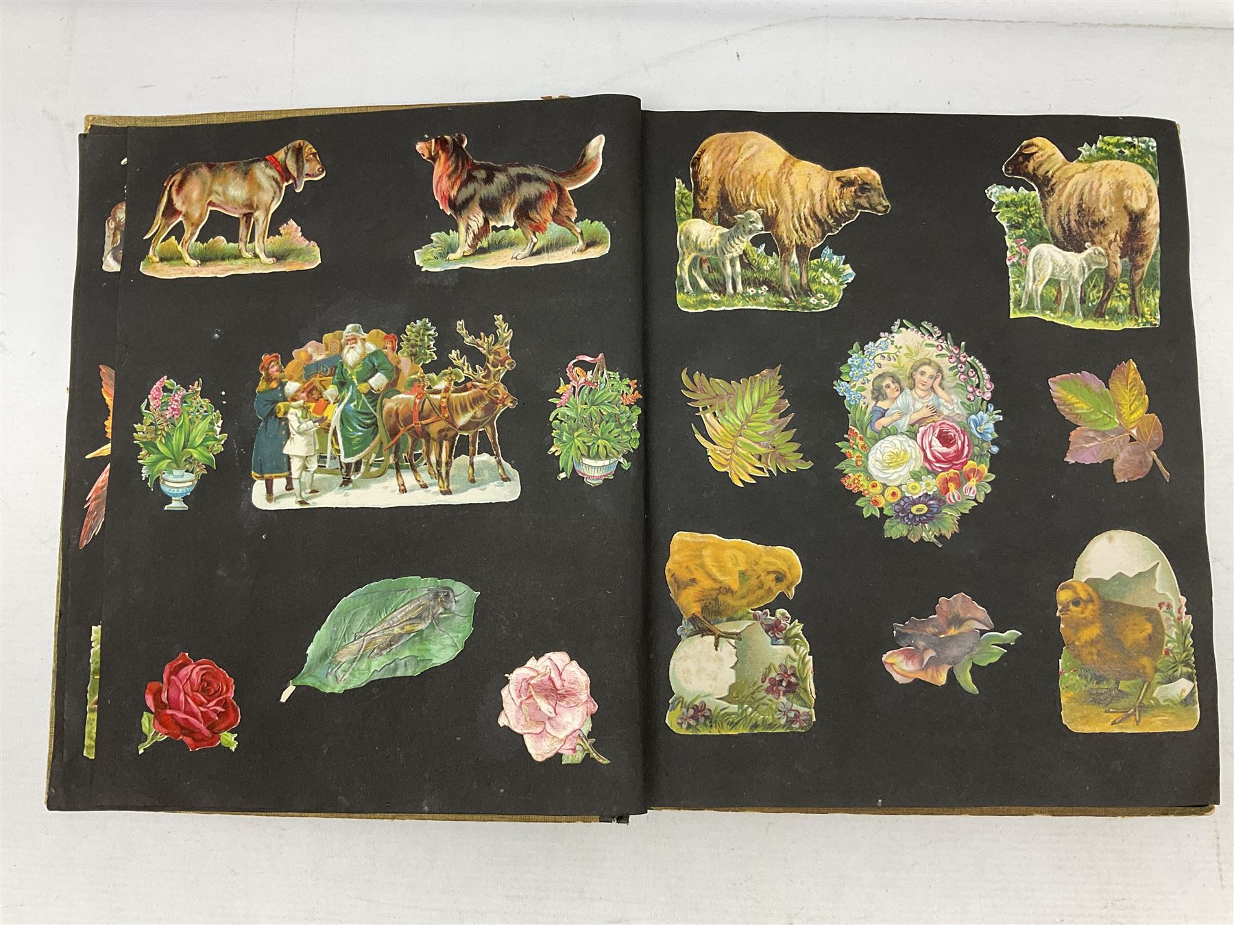 Victorian scrapbook containing twenty-six double sided pages and two fixed end pages of various fixed decoupage to include clippings of maritime interest, greeting cards, portraiture, flowers, animals etc, 